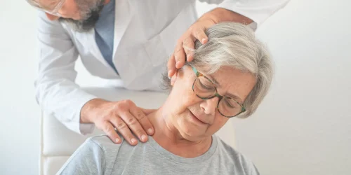 Spine surgeon examining patient with neck pain