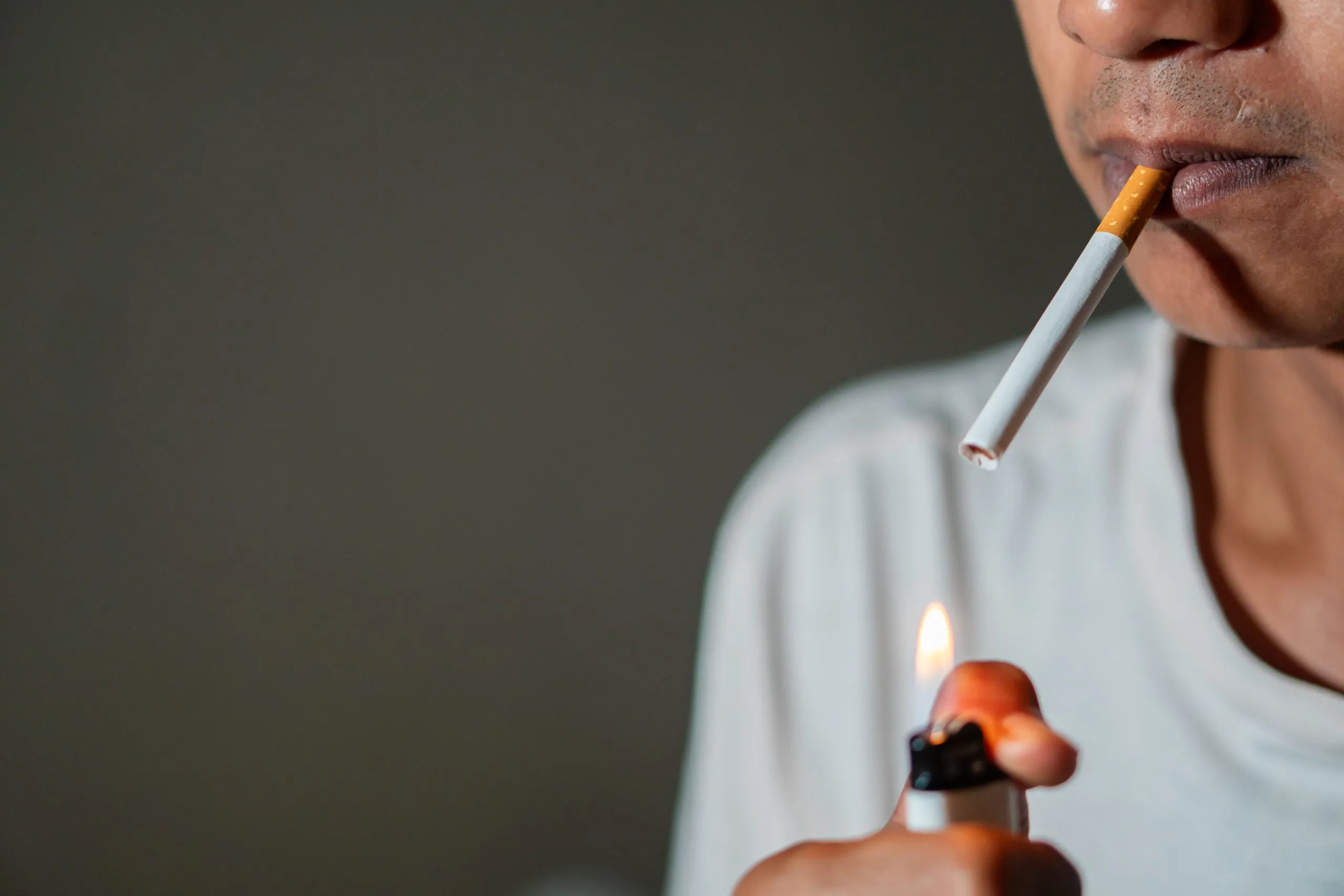 person-lighting-a-cigarette-with-a-lighter-2024-11-25-10-15-35-utc.jpg