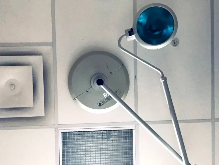 Medical examination lights and ceiling tiles in a clinic or hospital setting.