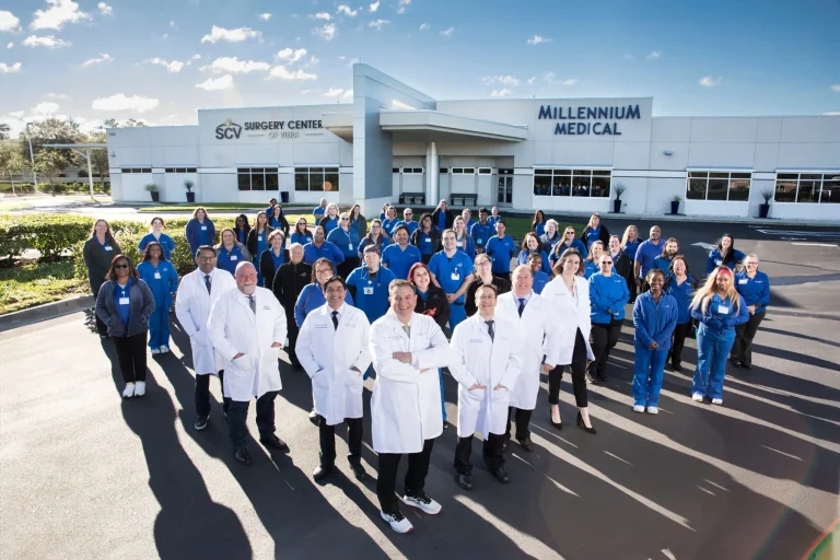 A group of medical professionals in front of Millennium Medical building.